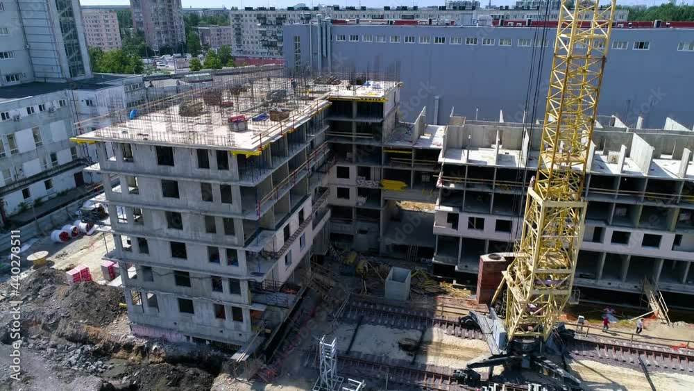 Monolithic house, installation of reinforcing steel and tower crane. Drone shot Monolithic house, installation of reinforcing steel and tower crane. Drone shot