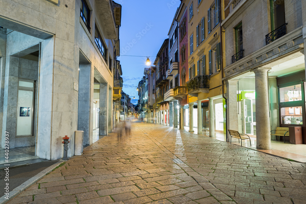 Typical street of the historic center of an Italian city in the evening. Historic center of Varese, Corso Matteotti, northern Italy