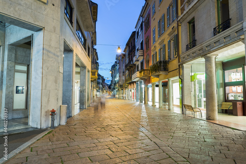 Typical street of the historic center of an Italian city in the evening. Historic center of Varese, Corso Matteotti, northern Italy