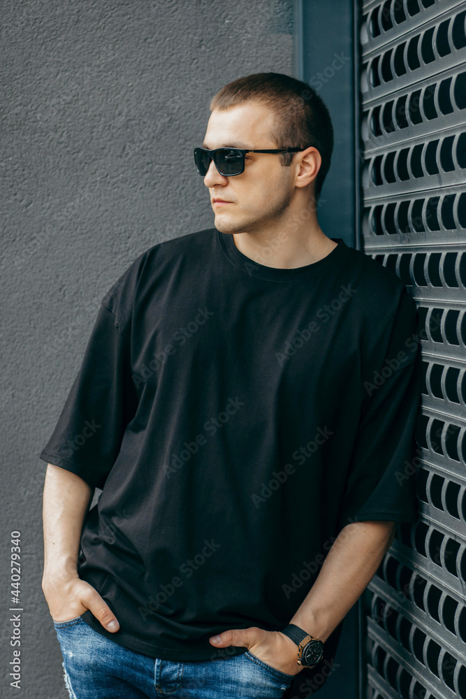 Man wearing black blank t-shirt with space for your logo or design. Mock up Man wearing black blank t-shirt with space for your logo or design. Mock up