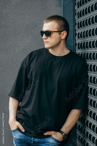 Man wearing black blank t-shirt with space for your logo or design. Mock up © andrew_shots