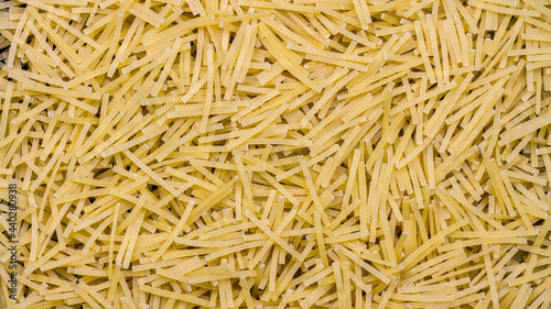 Pasta background, thin, organic raw vermicelli noodles, food texture