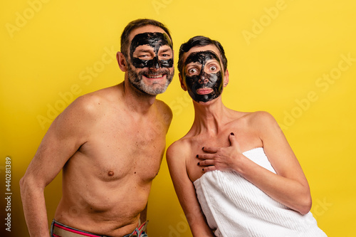 Mature couple with cosmetic mask on faces photo