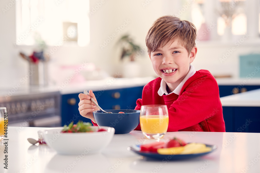 Laughing Boy Wearing School Uniform In Kitchen Eating Healthy Breakfast With Fresh Strawberry Laughing Boy Wearing School Uniform In Kitchen Eating Healthy Breakfast With Fresh Strawberry