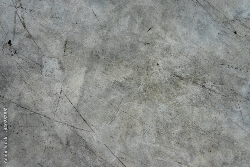 The background of the gray concrete floor is exhausted by black stripes. The background of the gray concrete floor is exhausted by black stripes.