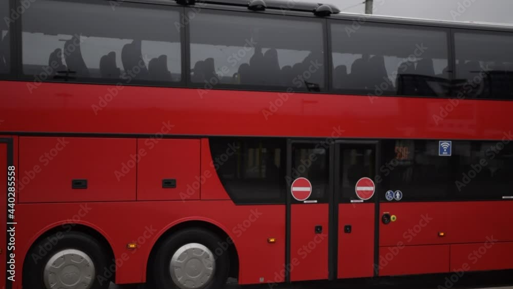 SLOW MOTION: Big Red Bus passing by on Rainy Road in Kassel, Germany Daylight 