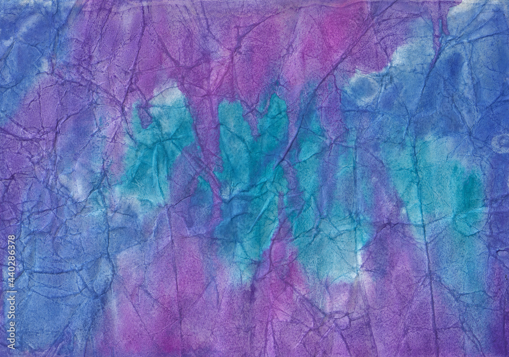 Blue, purple and lilac watercolor stains and streaks on crumpled paper