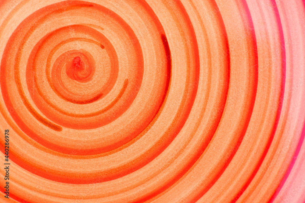 The red and yellow spiral pattern on a handmade dinner plate. The red and yellow spiral pattern on a handmade dinner plate.