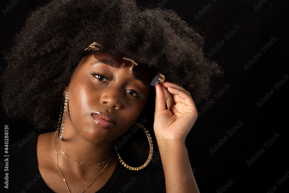 Beautiful young black woman with big hair and hoop earrings