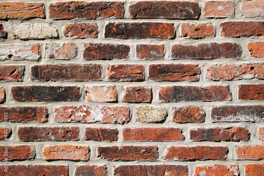 Fototapeta premium Old wall made of red bricks. Background with the surface of a brick wall.