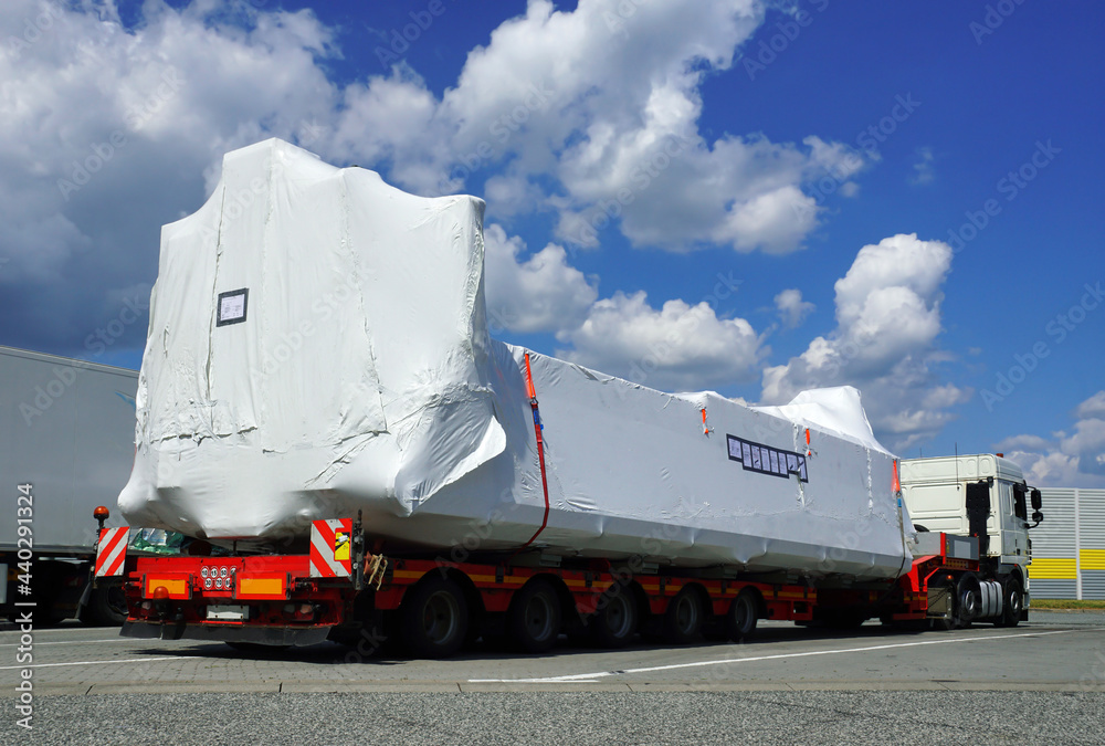 Very long vehicle. Oversize load or exceptional convoy. A truck with a  special semi-trailer for transporting oversized loads. Photos | Adobe Stock