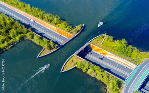 Aquaduct Veluwemeer, Nederland. Aerial view from the drone. A sailboat sails through the aqueduct on the lake above the highway. photo