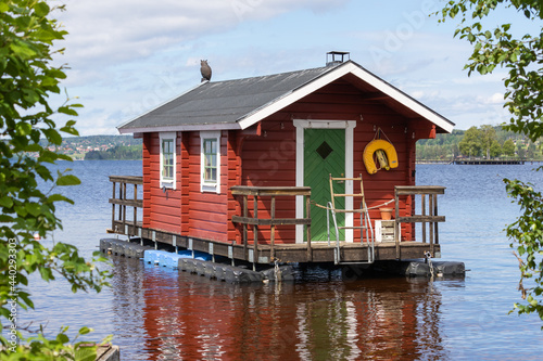 small cabin floating on a lake in the Swedish countryside photo