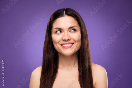 Photo of charming happy mature woman look empty space smooth flawless skin isolated on purple color background