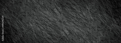 Rock texture with cracks,black stone background with copy space for design.