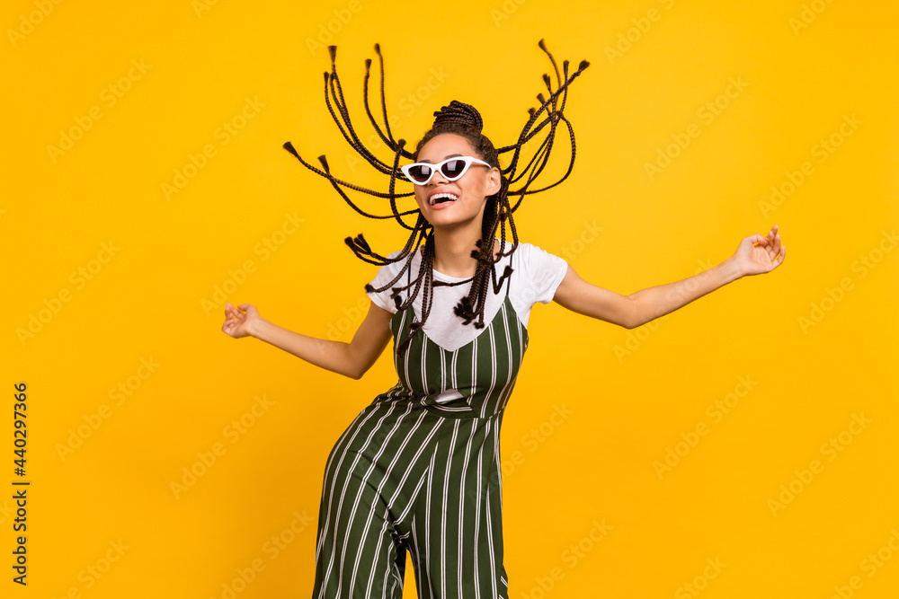 Photo of young black girl happy positive smile fly air hair wear sunglass summer isolated over yellow color background