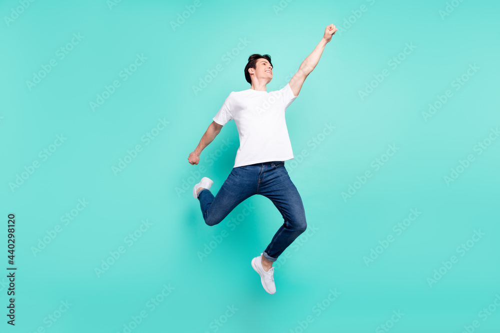 Full body photo of cool brunet hairdo teen guy super man wear t-shirt jeans isolated on teal background