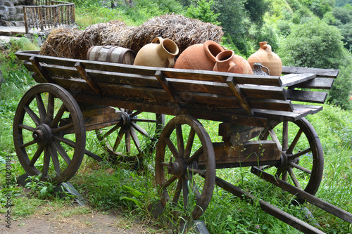 Old wooden cart with clay jugs