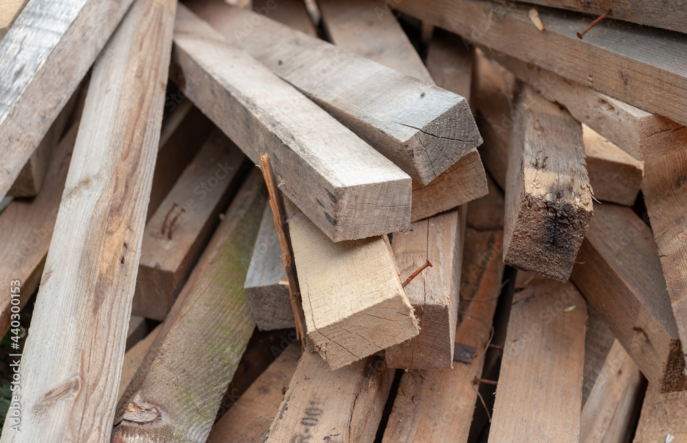 Stacked planks of disassembled pallets with more nails in them. Stacked planks of disassembled pallets with more nails in them.