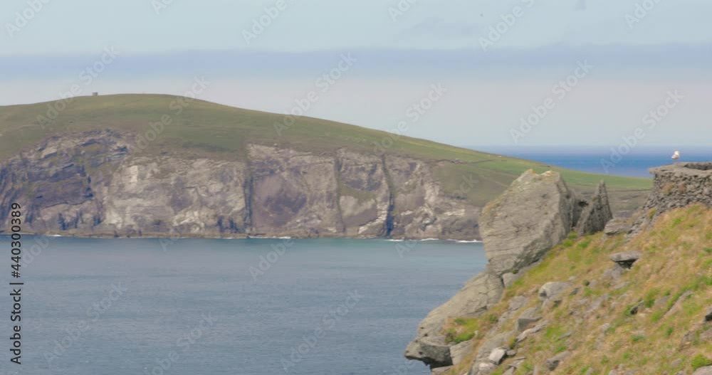 Panoramic view overlooking Dingle Peninsula and sea, Ireland, on sunny day. Panning shot. Panoramic view overlooking Dingle Peninsula and sea, Ireland, on sunny day. Panning shot.