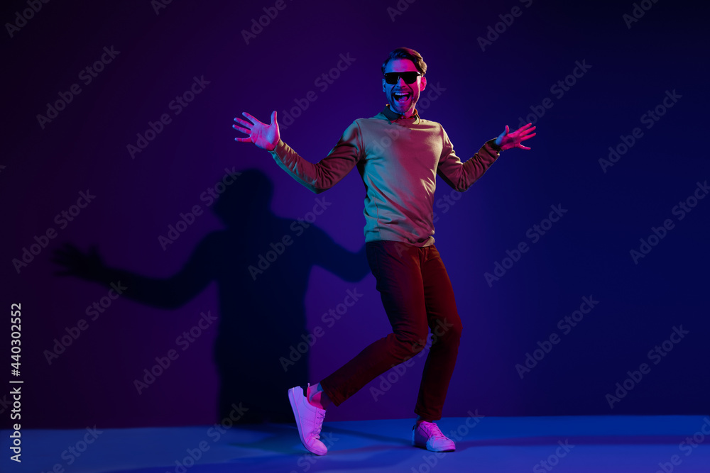 Fototapeta premium Full size photo of cheerful young funky man dance wear sunglass night club life isolated on neon background