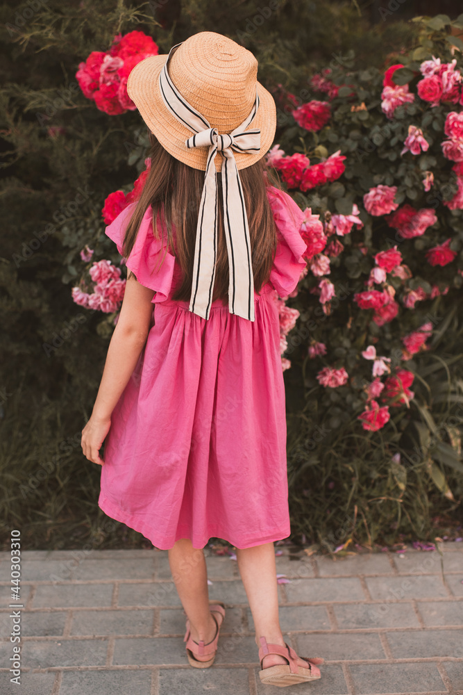 Cute child girl 5-6 year old wear straw hat with bow and summer dress ...