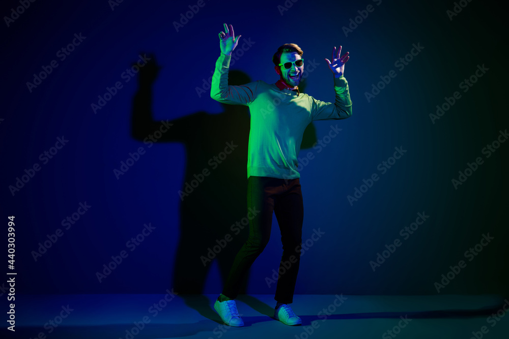 Full body photo of young man happy positive smile enjoy music nightclub dance hipster isolated over dark color background