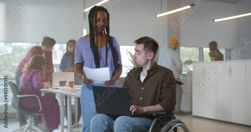 Wallpaper Mural Young man in wheelchair working with female colleague Torontodigital.ca