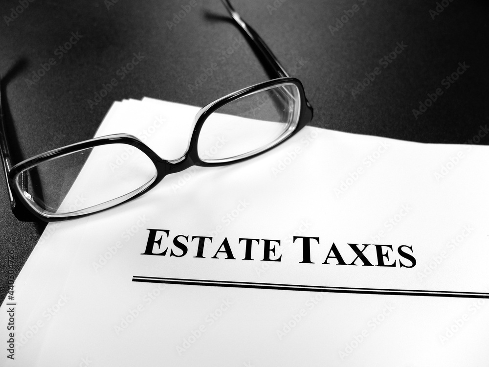 Estate Tax Taxes Documents on Desk with Glasses Estate Tax Taxes Documents on Desk with Glasses