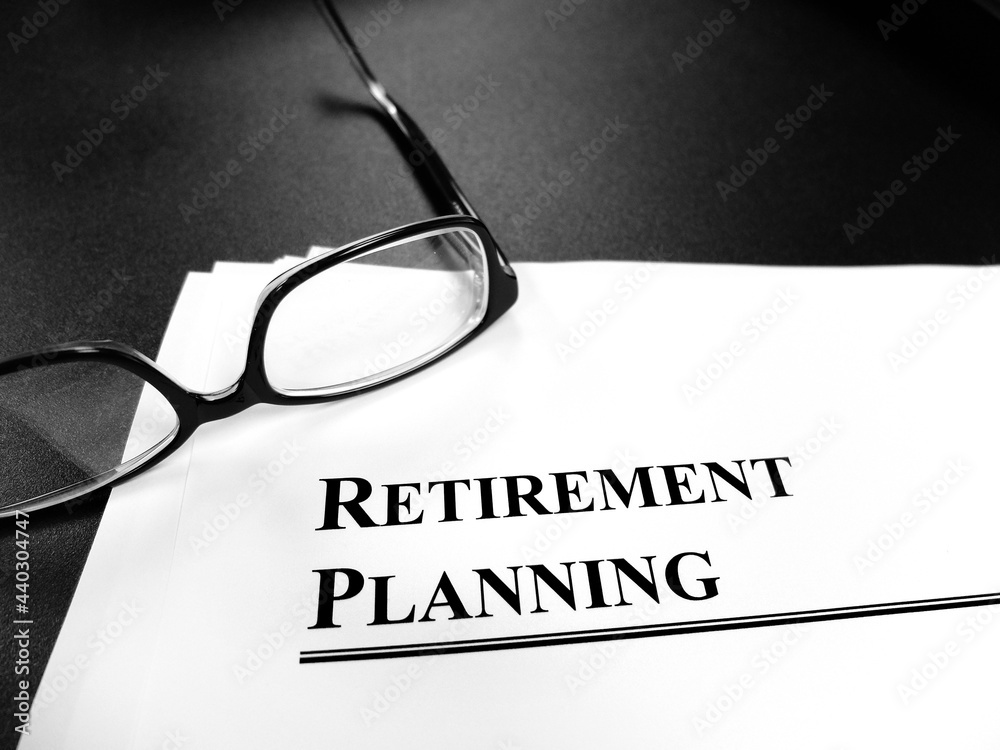 Retirement Planning Documents on Desk with Glasses Retirement Planning Documents on Desk with Glasses