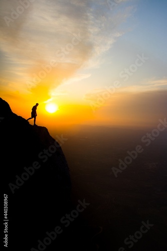 silhouette of a person on a rock