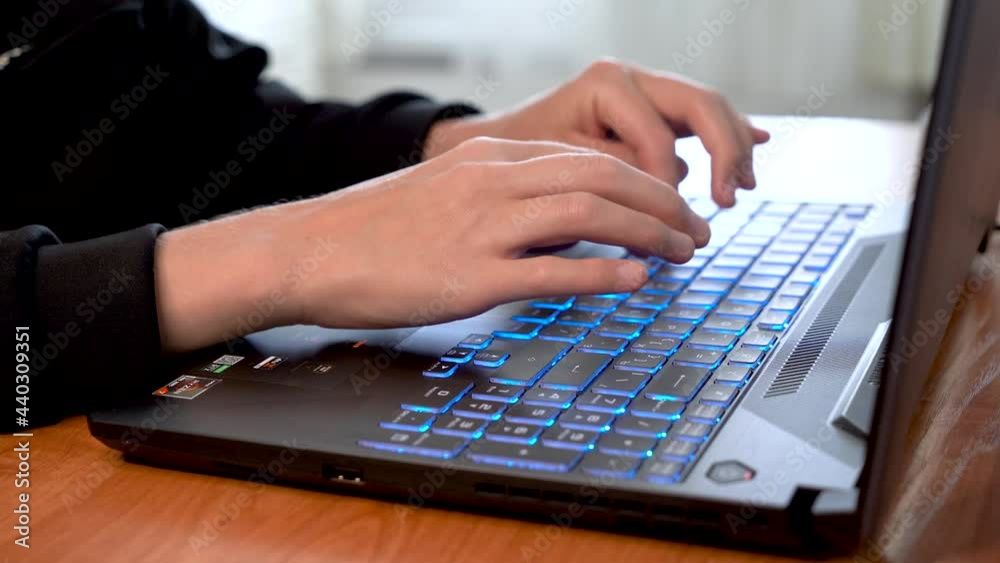 Women's beautiful hands typing on a laptop keyboard close-up. Blurred background. Women's beautiful hands typing on a laptop keyboard close-up. Blurred background.