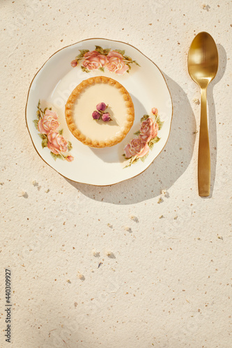 small pie with dried roses and gold spoon