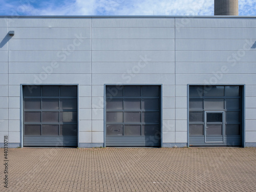 Truck doors in a workshop or loading docks. rolling gates for trucks. Facade of a warehouse or workshop.