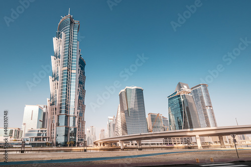 Luxury high skyscrapers with offices, hotels and residential buildings in UAE. The road over the bridge and flyover passes through the Dubai Creek Canal