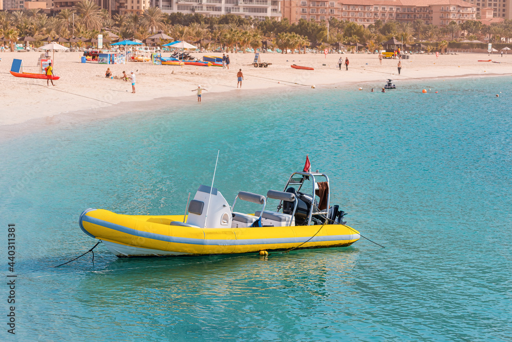 Yellow speedboat awaits tourists for tours and excursions around the Persian Gulf in Dubai. Transportation and active entertainment