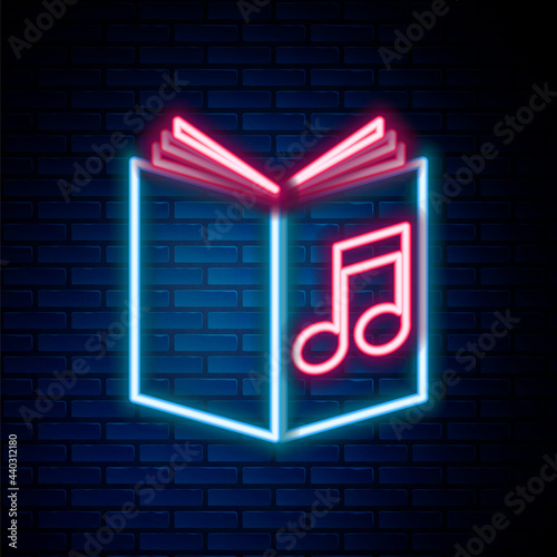 Glowing neon line Audio book icon isolated on brick wall background. Musical note with book. Audio guide sign. Online learning concept. Colorful outline concept. Vector