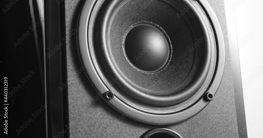 Zooming on black varnished music speaker with woofer vibrating with bass Zooming on black varnished music speaker with woofer vibrating with bass