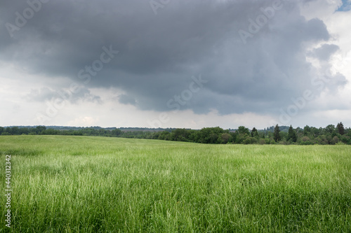 green field before a thunderstorm