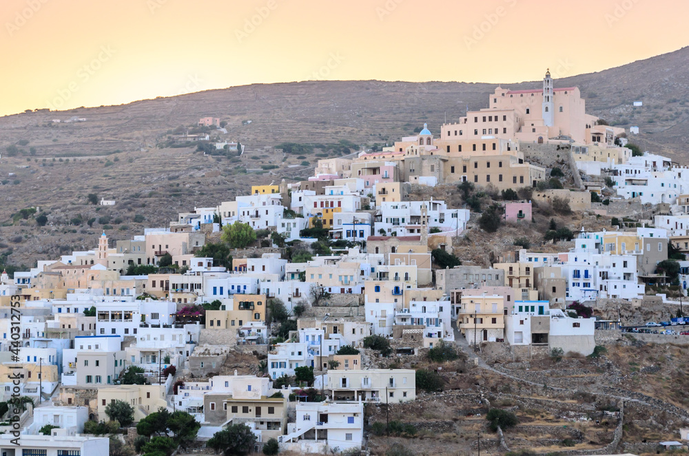 Upper Side of Syros Island in Greece, During Sunset Time. Catholic Church at the Top of the Hill. Traditional White Houses Form a Pattern.