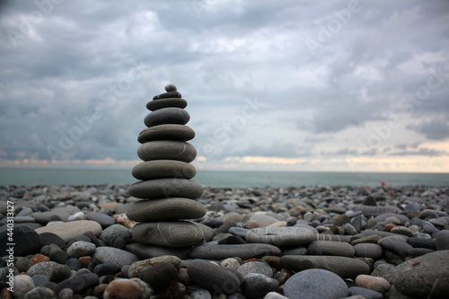 A pyramid of stones on the seashore.