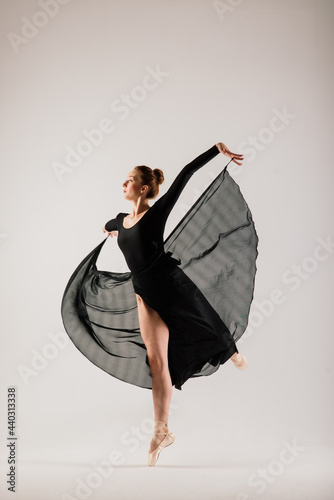 Photography Portarit of Sensual professional caucasian callet dancer in body suit and pointes shoes on white