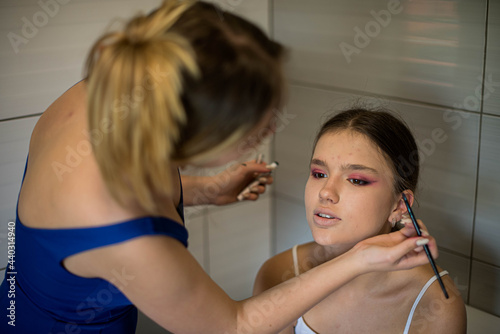 Make-up artist work on her friend. Real people.