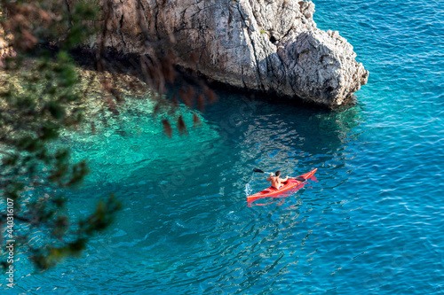 A man on a kayak swims on the sea