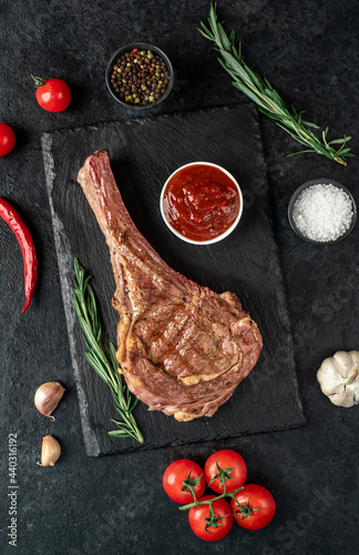 Grilled tomahawk steak on stone background 