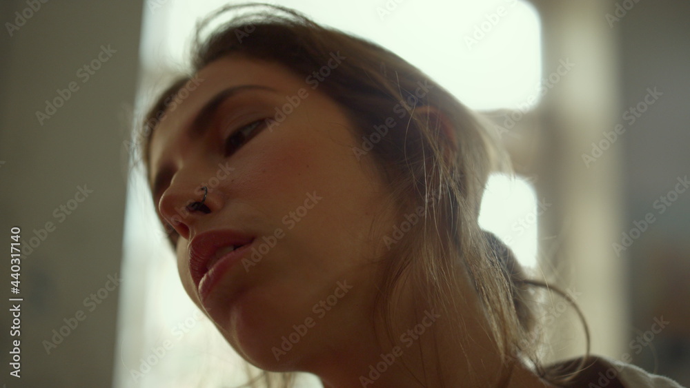 Inspired woman looking to canvas indoors. Talented painter working in studio.