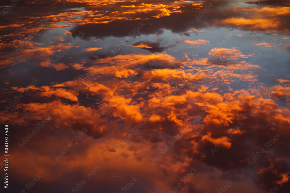 golden orange glowing clouds at sunrise abstract background
