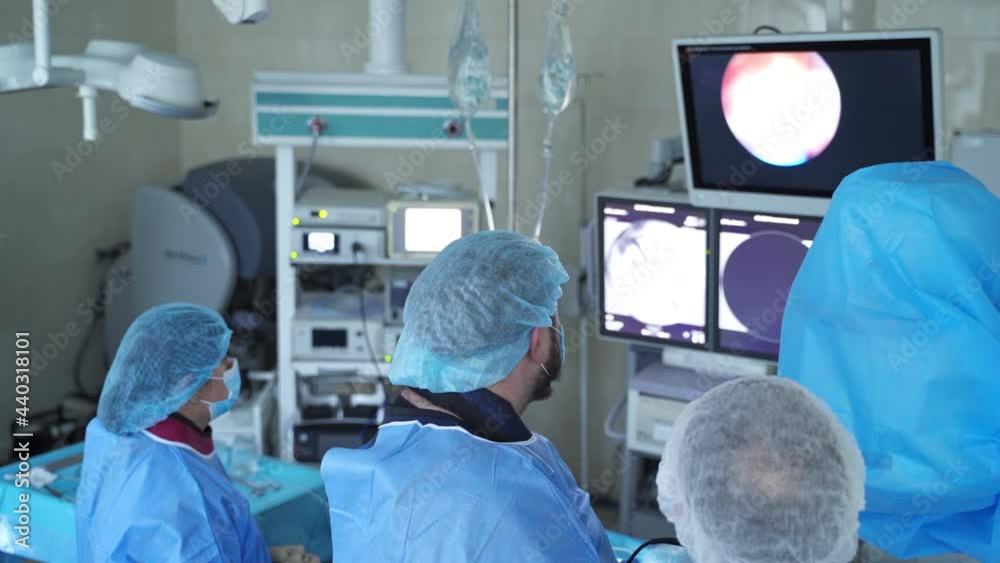 Group of surgeons operating in emergency ward. Surgery doctor with assistants operating with anesthesia. Group of surgeons operating in emergency ward. Surgery doctor with assistants operating with anesthesia.
