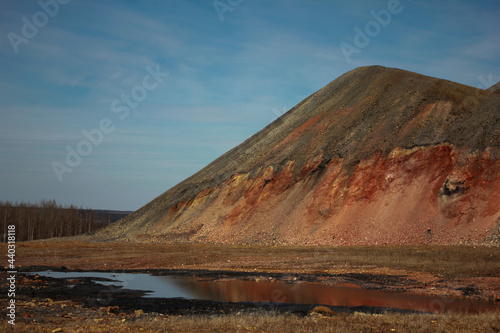 Industrial landscape in the Urals. Slag dumps near a coal mine. An interesting mountain reminiscent of the Egyptian pyramid. Mine waste heap. Dead zone. Industrialization.