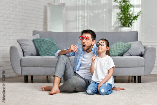 dad and little kid girl holding paper glasses © producer